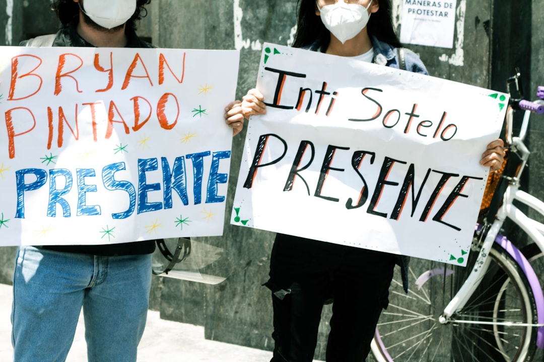 woman in white shirt holding white and blue signage