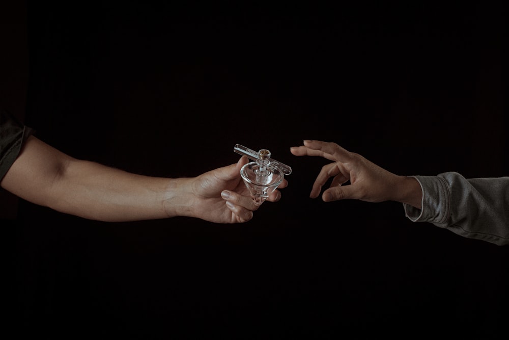 person holding silver and gold bracelet