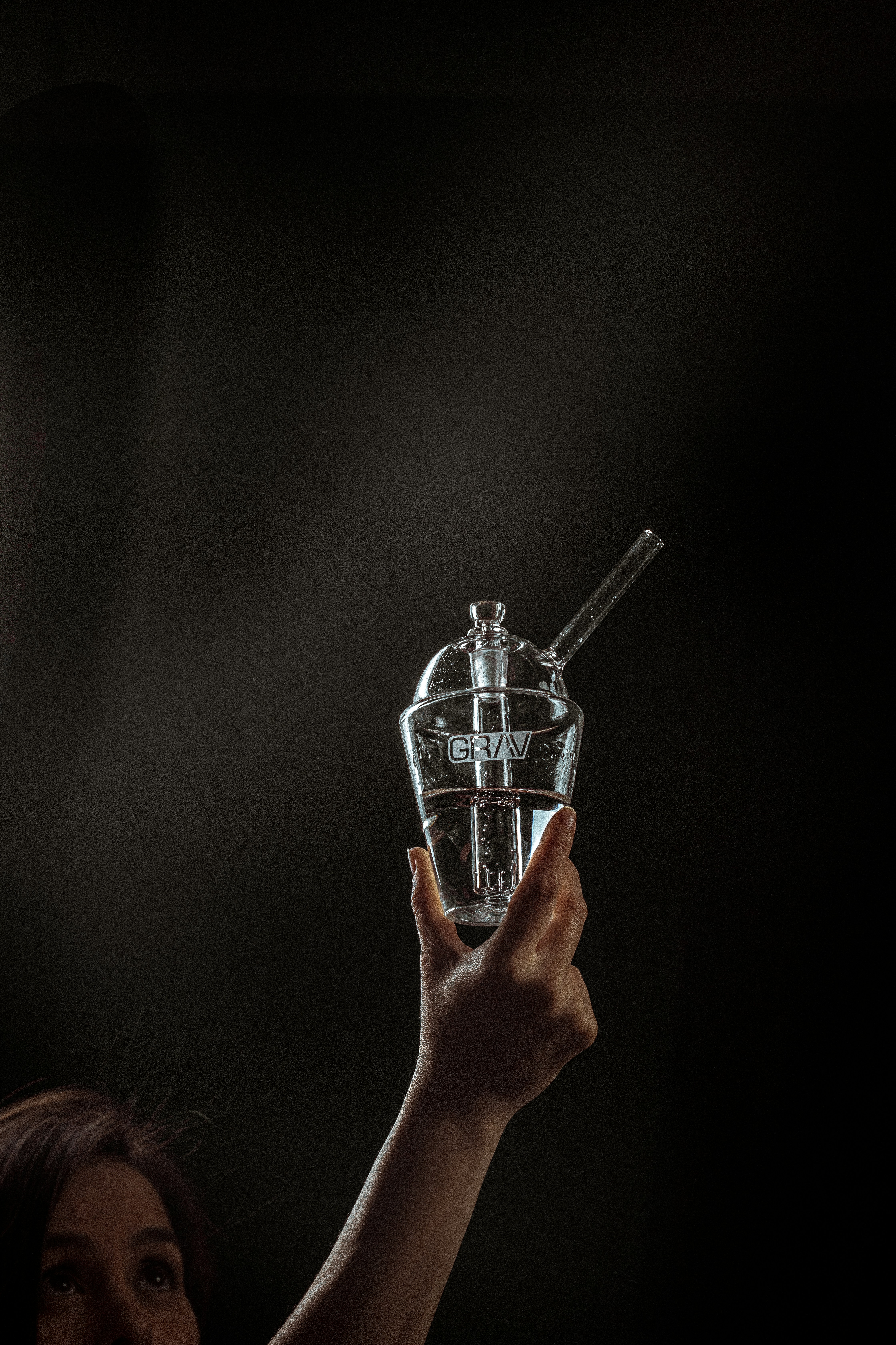 person holding silver and black trophy