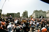 A lively political rally with people holding banners in a Yucatán town square