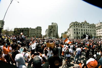 A lively political rally with people holding banners in a Yucatán town square