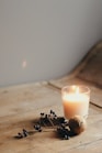 white candle on brown wooden table