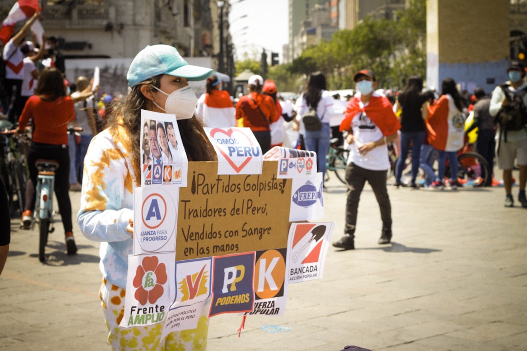 people holding white and blue banner during daytime