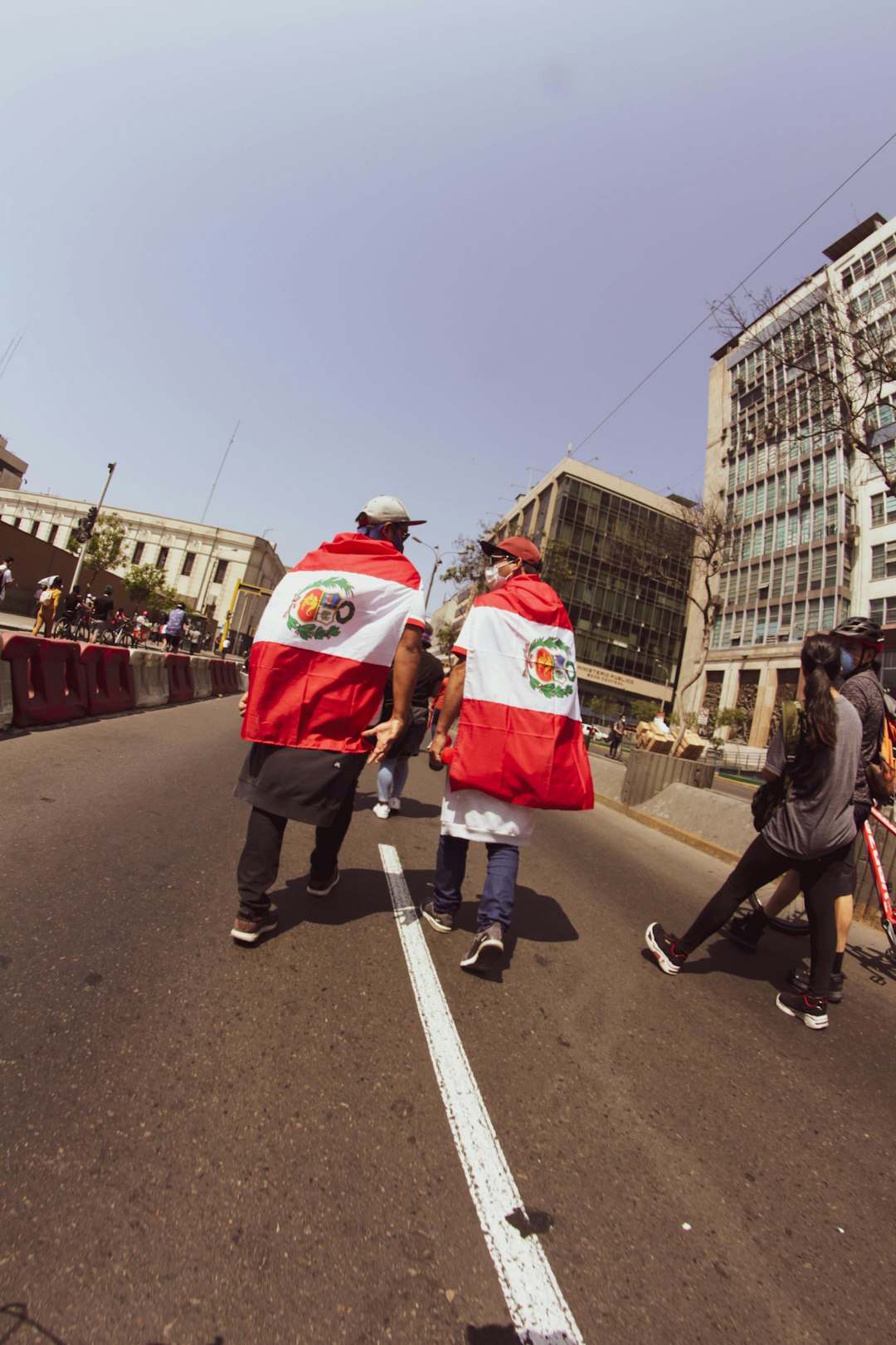 man in red and white santa costume walking on street during daytime