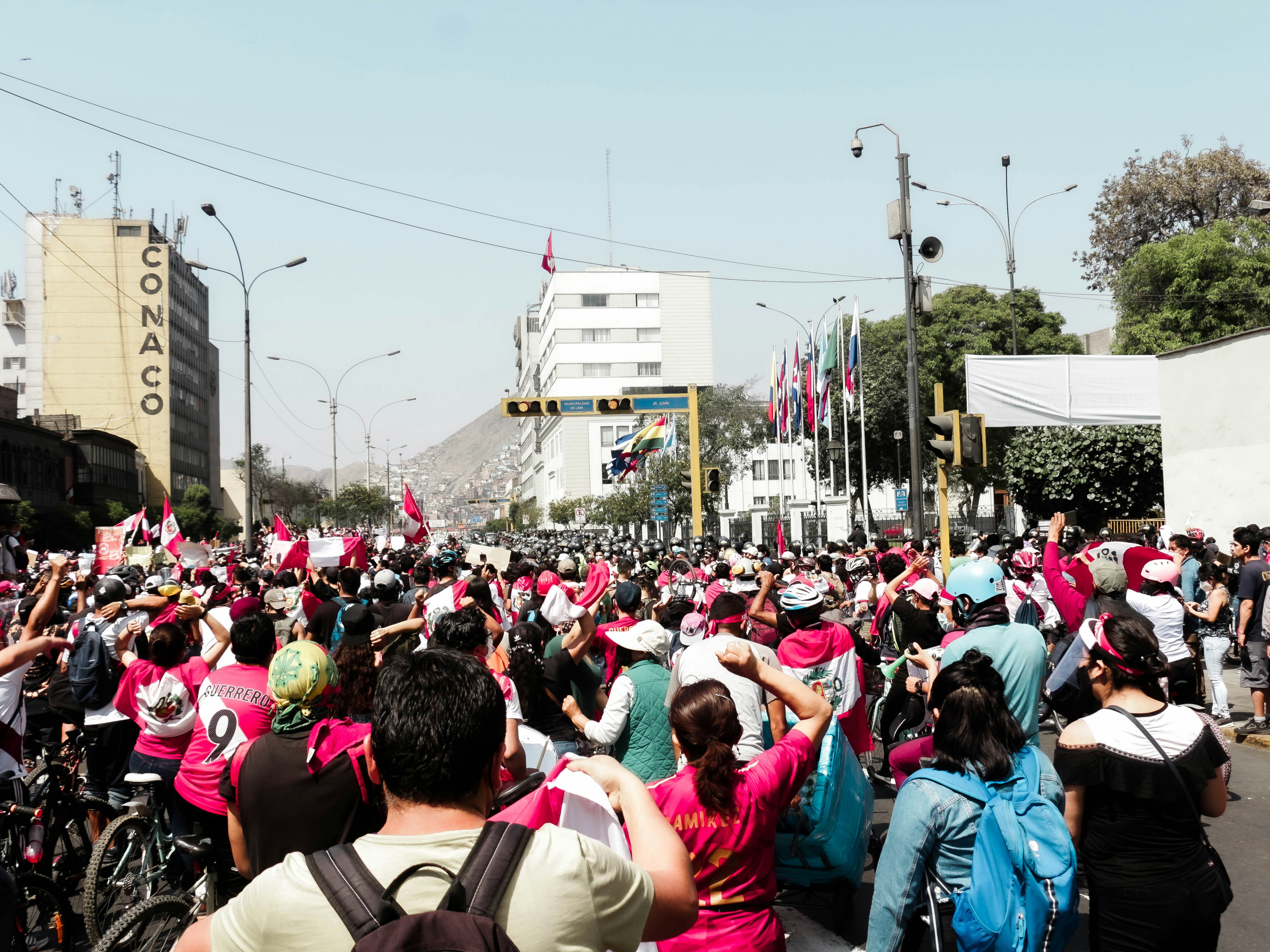 A close-up shot of a woman holding a sleek, pink smart card. The card has a subtle BJP lotus symbol and some Hindi text visible.