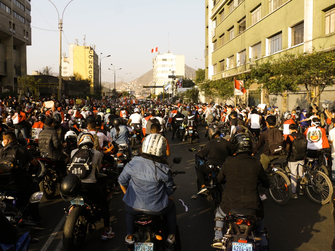 people riding motorcycle on road during daytime