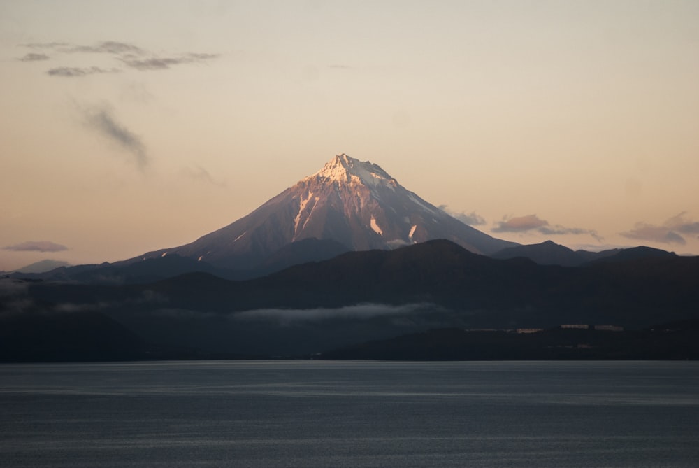 snow covered mountain under cloudy sky during daytime