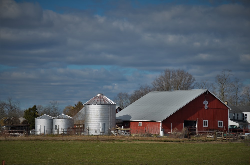 red and white barn under cloudy sky