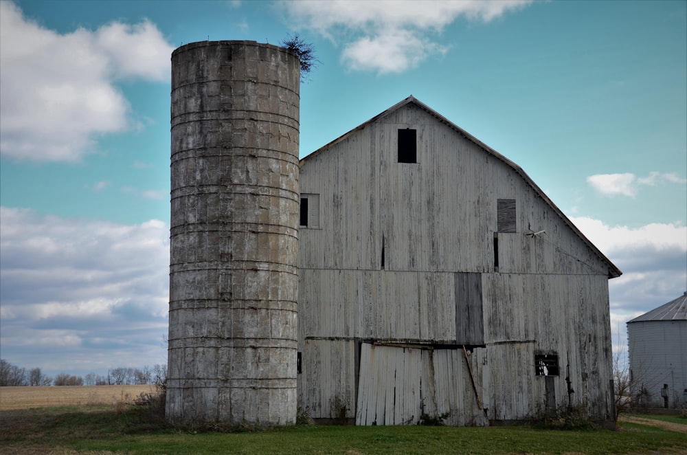 brown wooden barn on green grass field