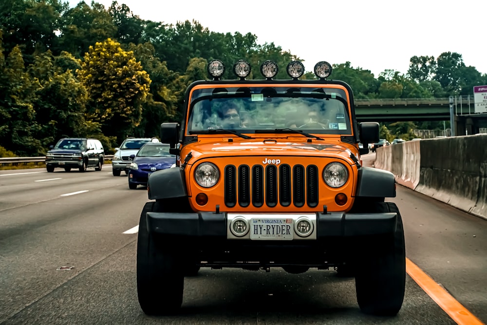 yellow and black jeep wrangler on road during daytime