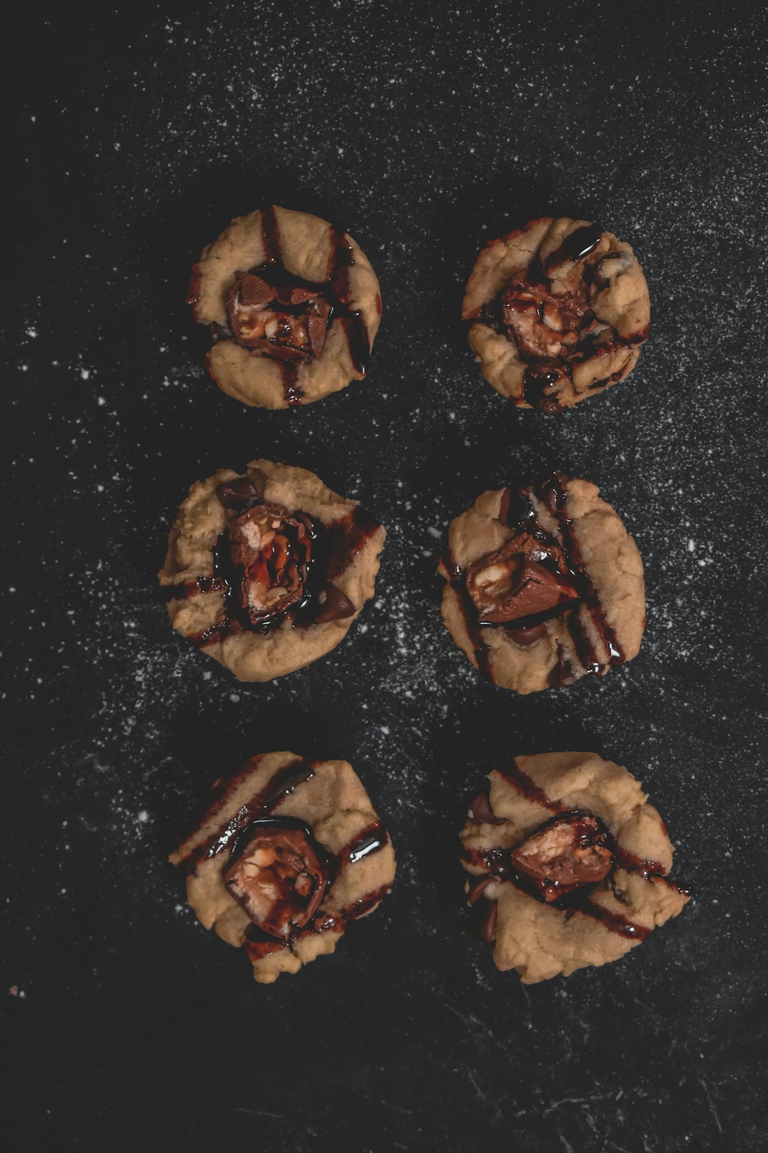 brown cookies on black surface