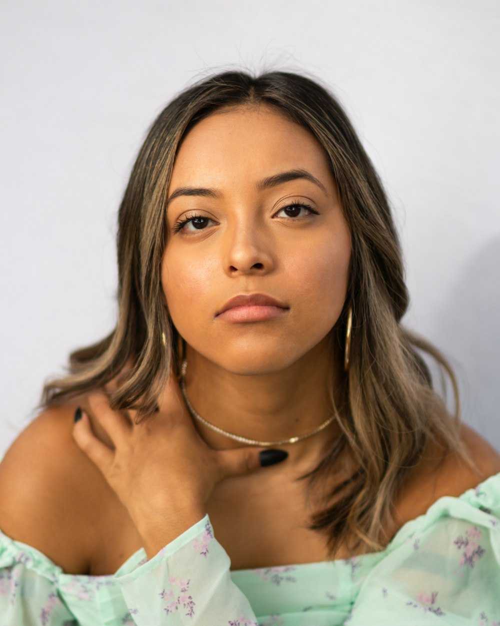 woman in white and blue floral shirt