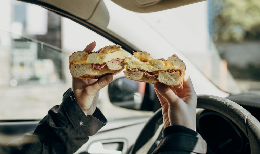 person holding bread with meat