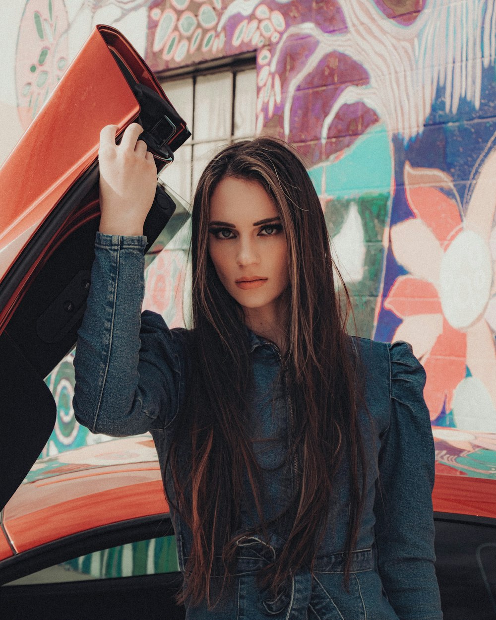 woman in black leather jacket holding black smartphone