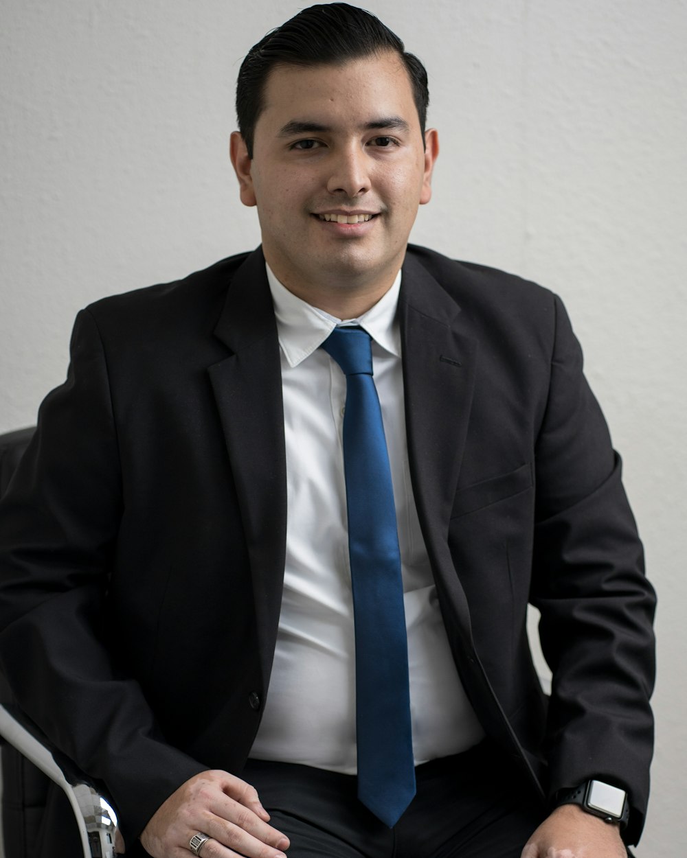 man in black suit jacket and blue necktie