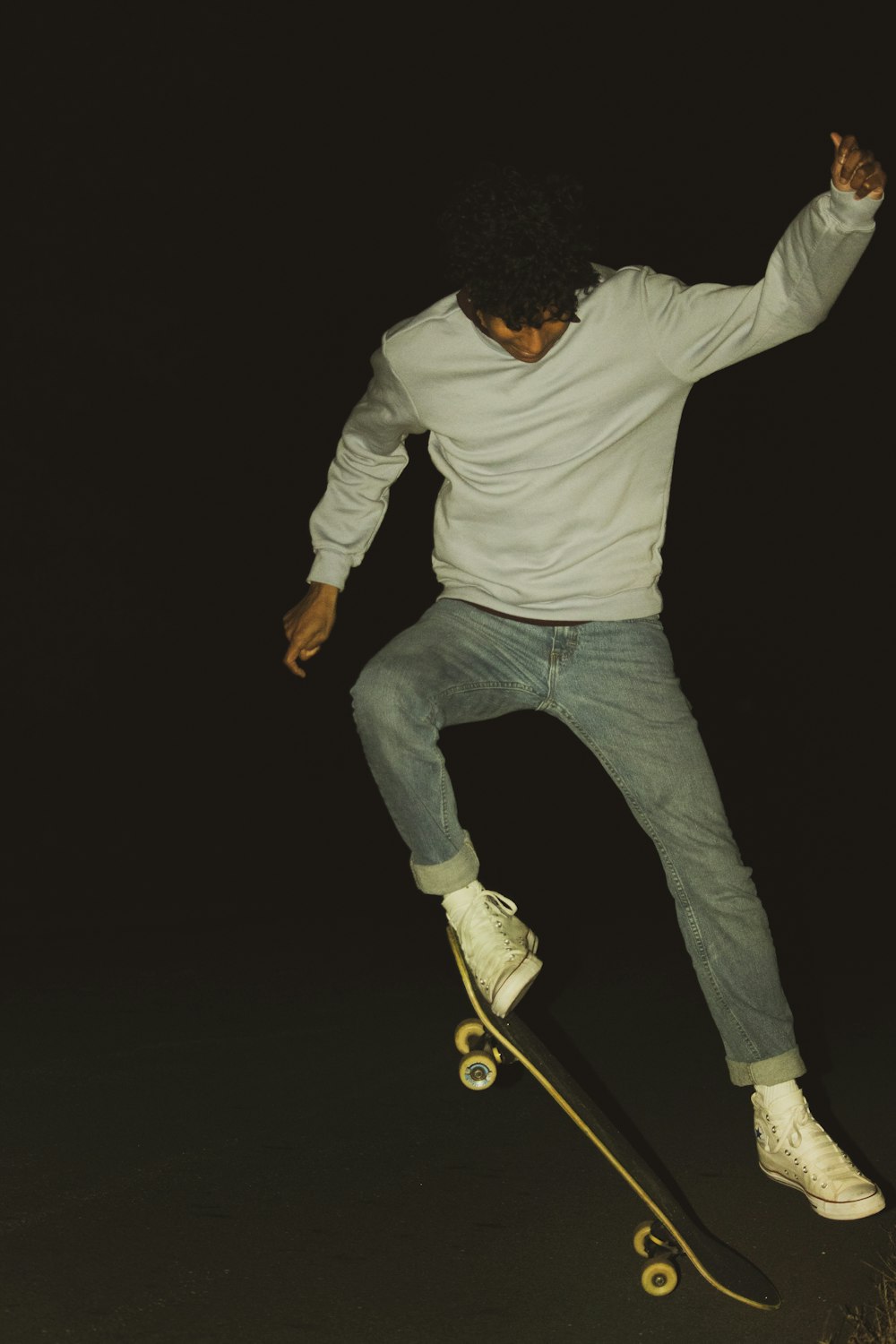 man in white long sleeve shirt and blue denim jeans