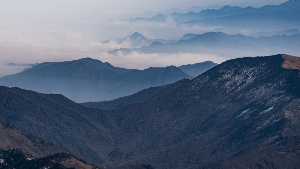 green and brown mountains under white clouds during daytime