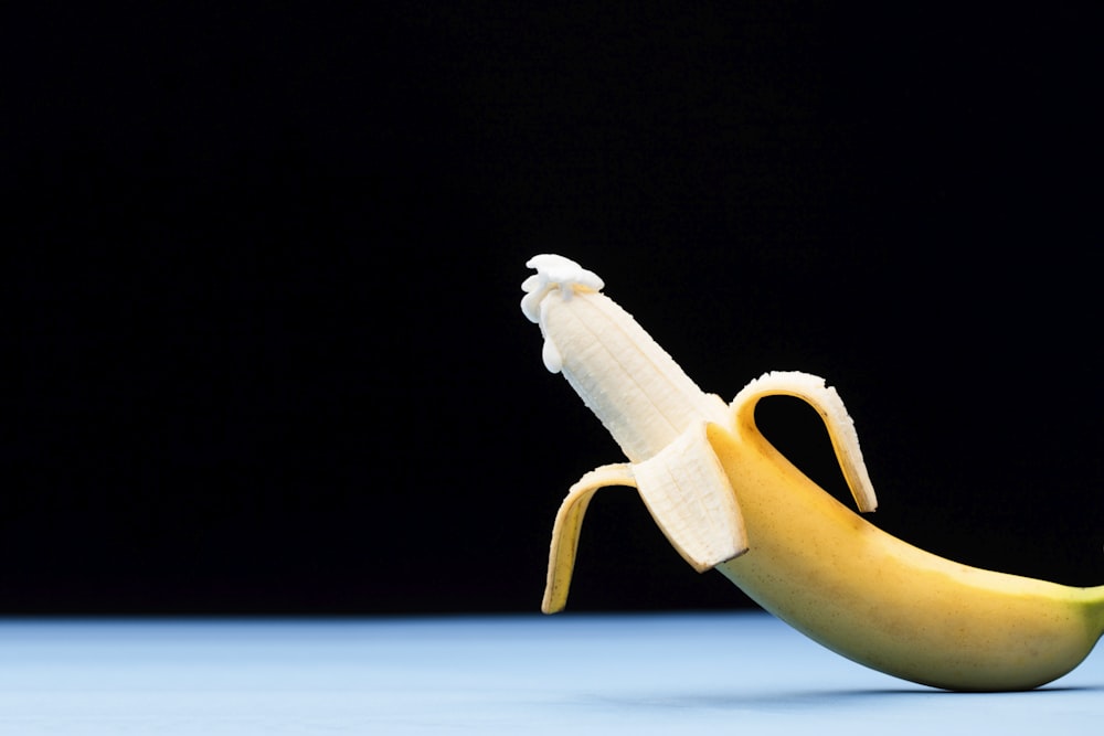 yellow banana fruit on black surface