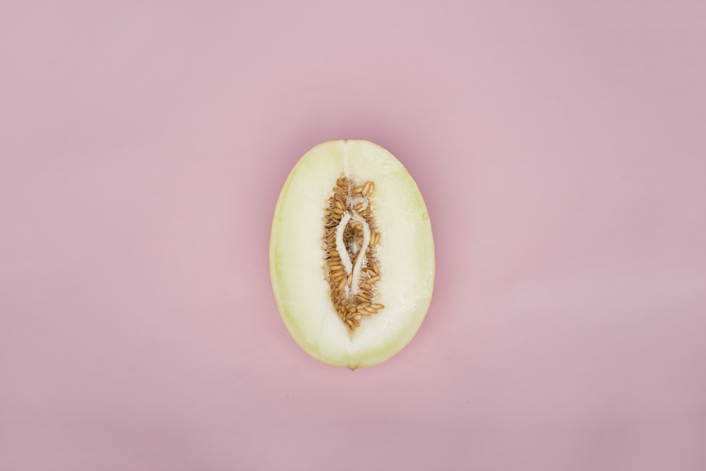 sliced green fruit on pink surface