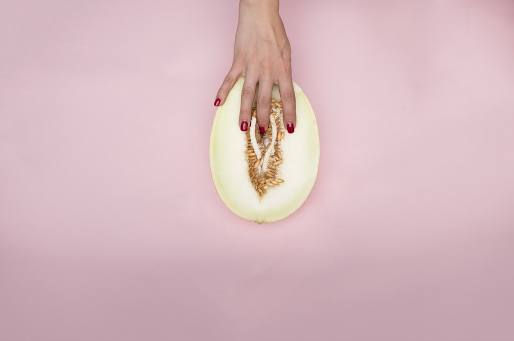 person holding white round ornament