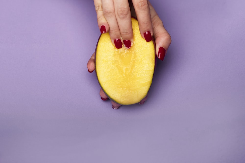 person holding sliced of watermelon