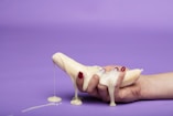 white ceramic figurine on purple surface