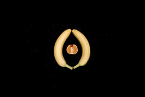 Sliced yellow fruit on a dark background, symbolizing feminine energy, intimacy, and women’s sexual 