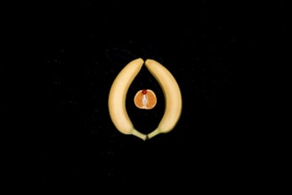 Sliced yellow fruit on a dark background, symbolizing feminine energy, intimacy, and women’s sexual 