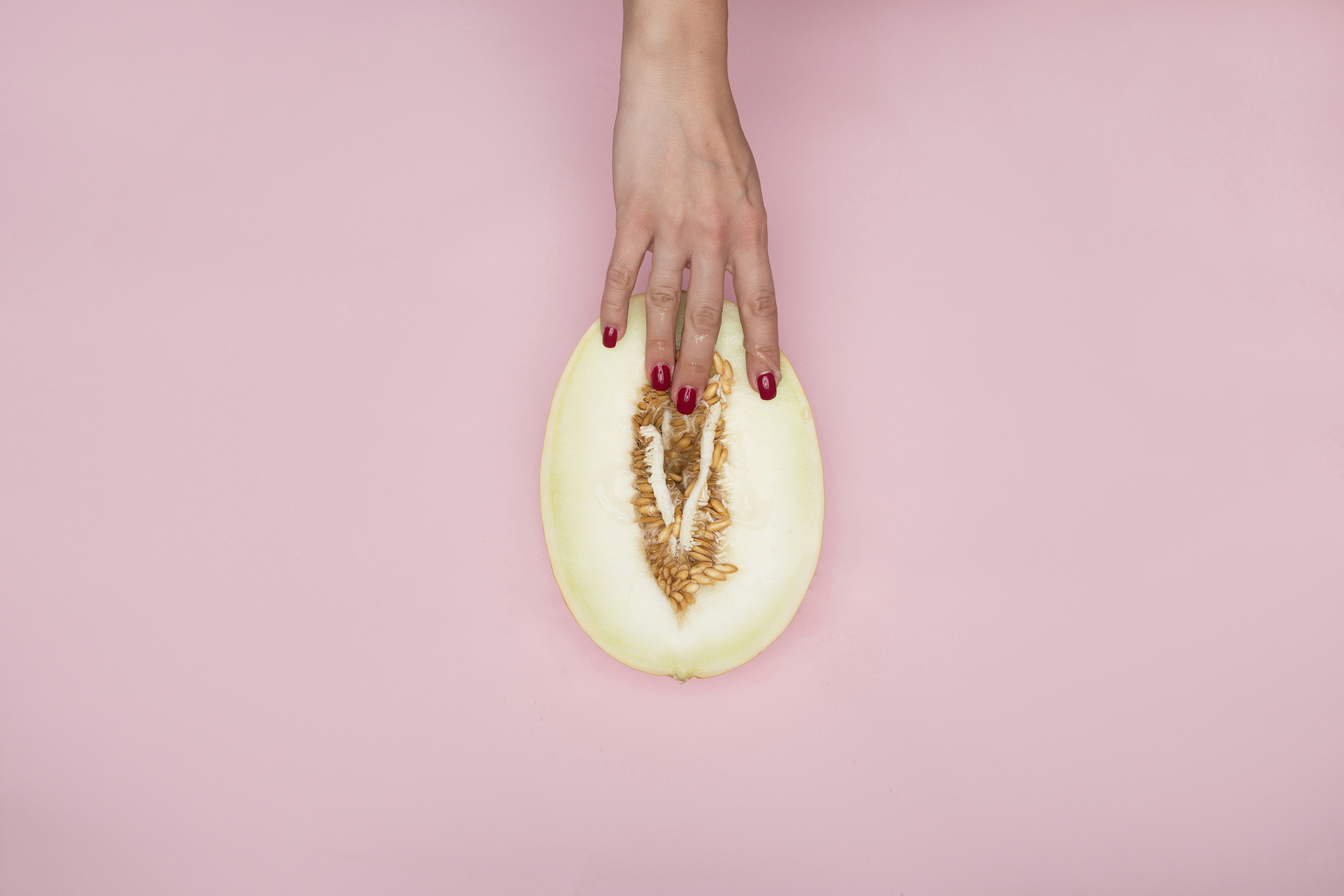 person holding sliced of green fruit