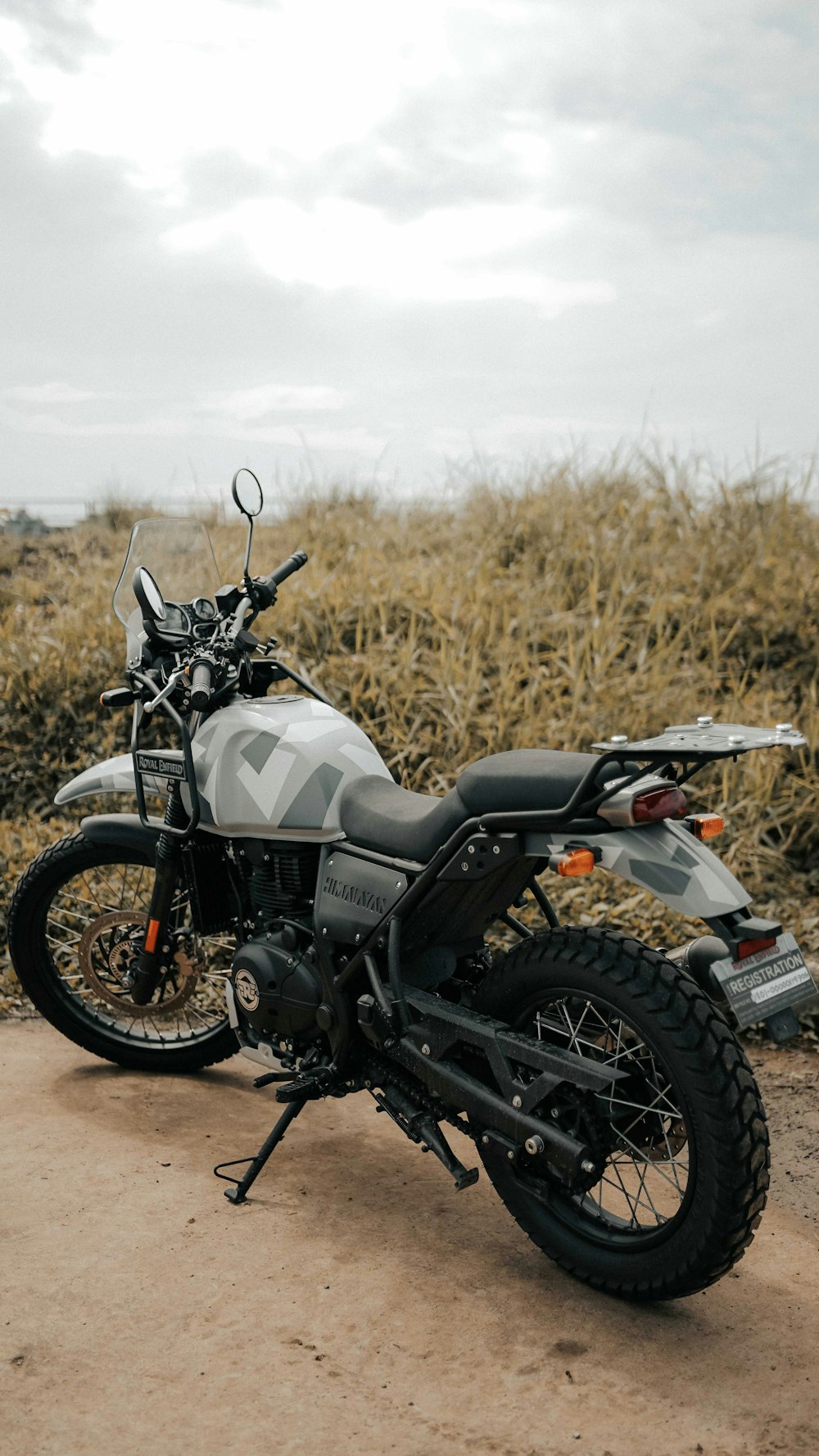 black and gray motorcycle on brown grass field during daytime
