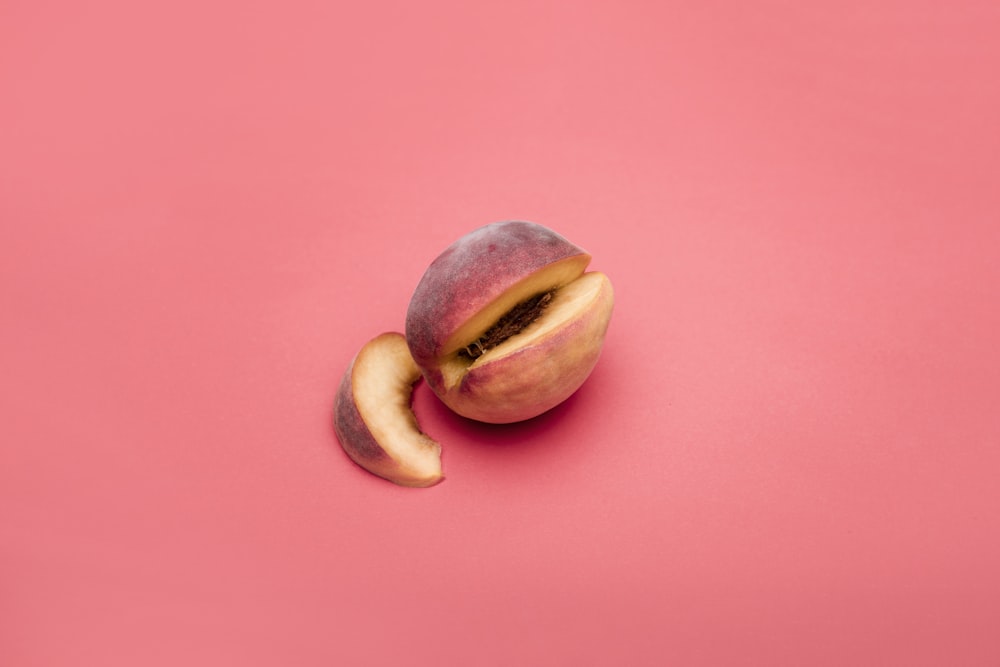 sliced apple fruit on pink surface