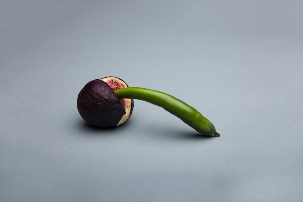 green and brown fruit on white table