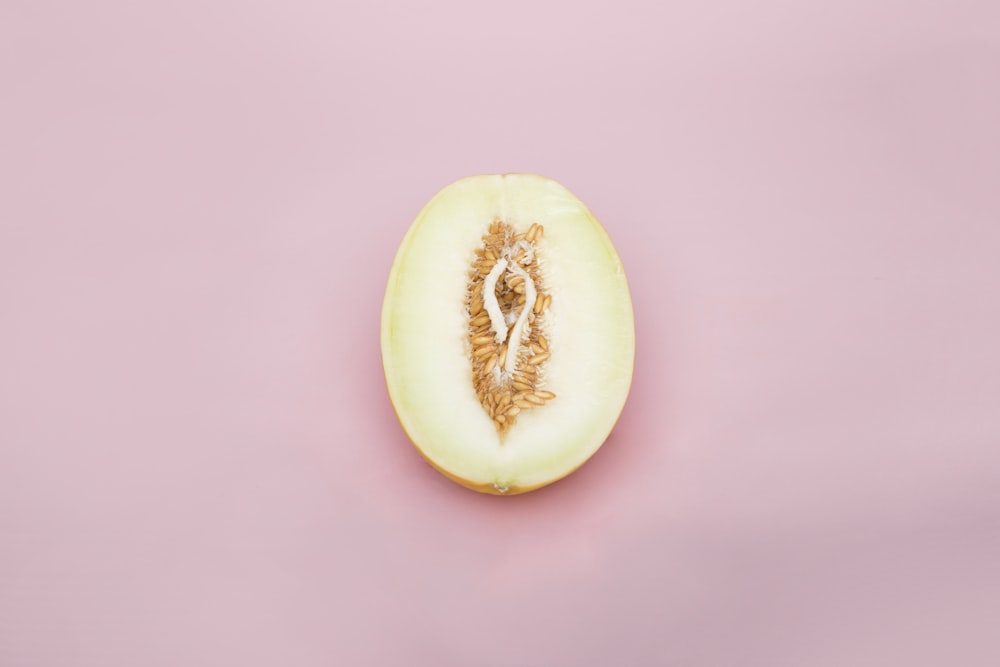 sliced yellow fruit on pink surface