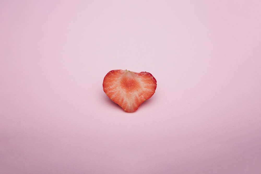 sliced red fruit on white surface