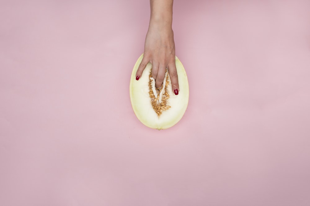 person holding sliced of apple