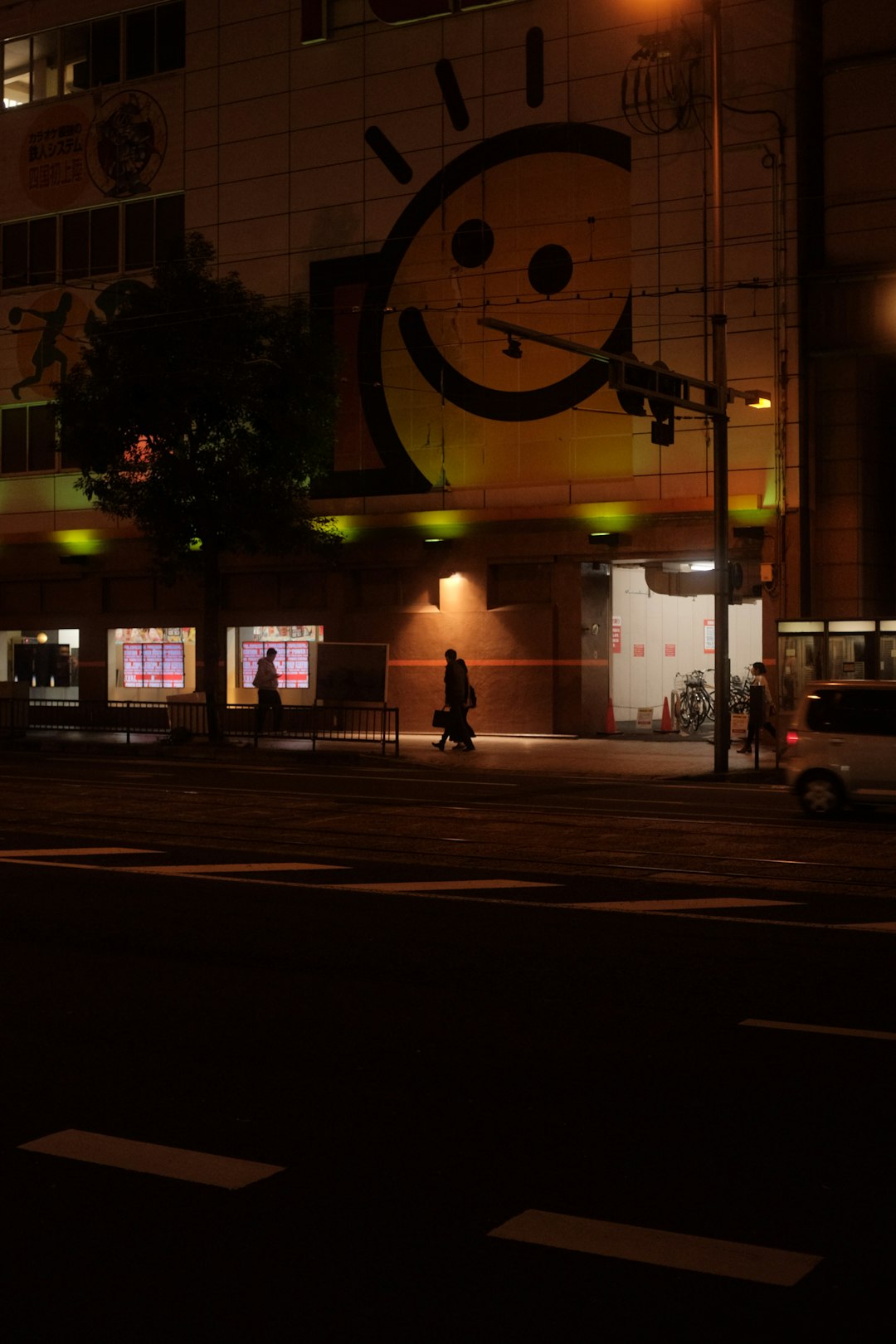 person walking on sidewalk during night time