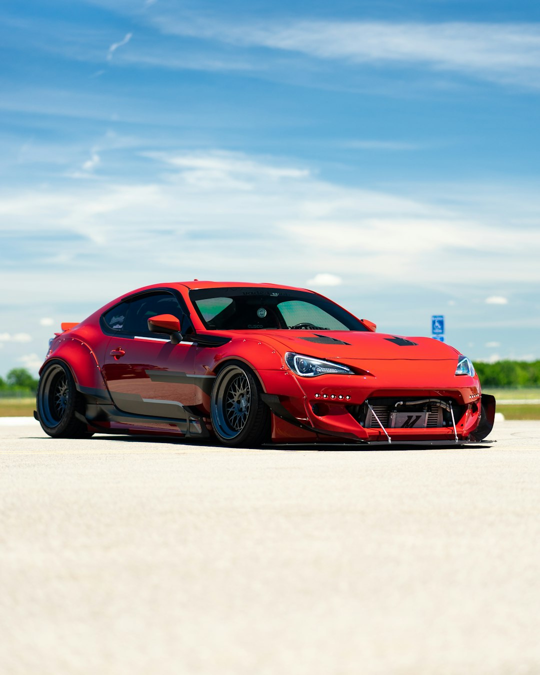 red porsche 911 on white sand during daytime