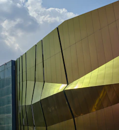 Close-up of a sleek aluminum façade with sunlight reflecting off its clean lines.