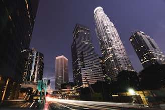 A bustling city skyline at night, lights twinkling under a clear sky, inviting adventure.