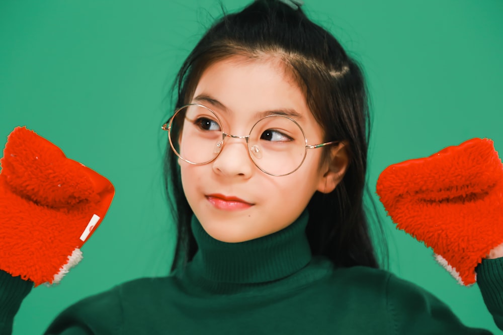 woman in green turtleneck sweater wearing eyeglasses