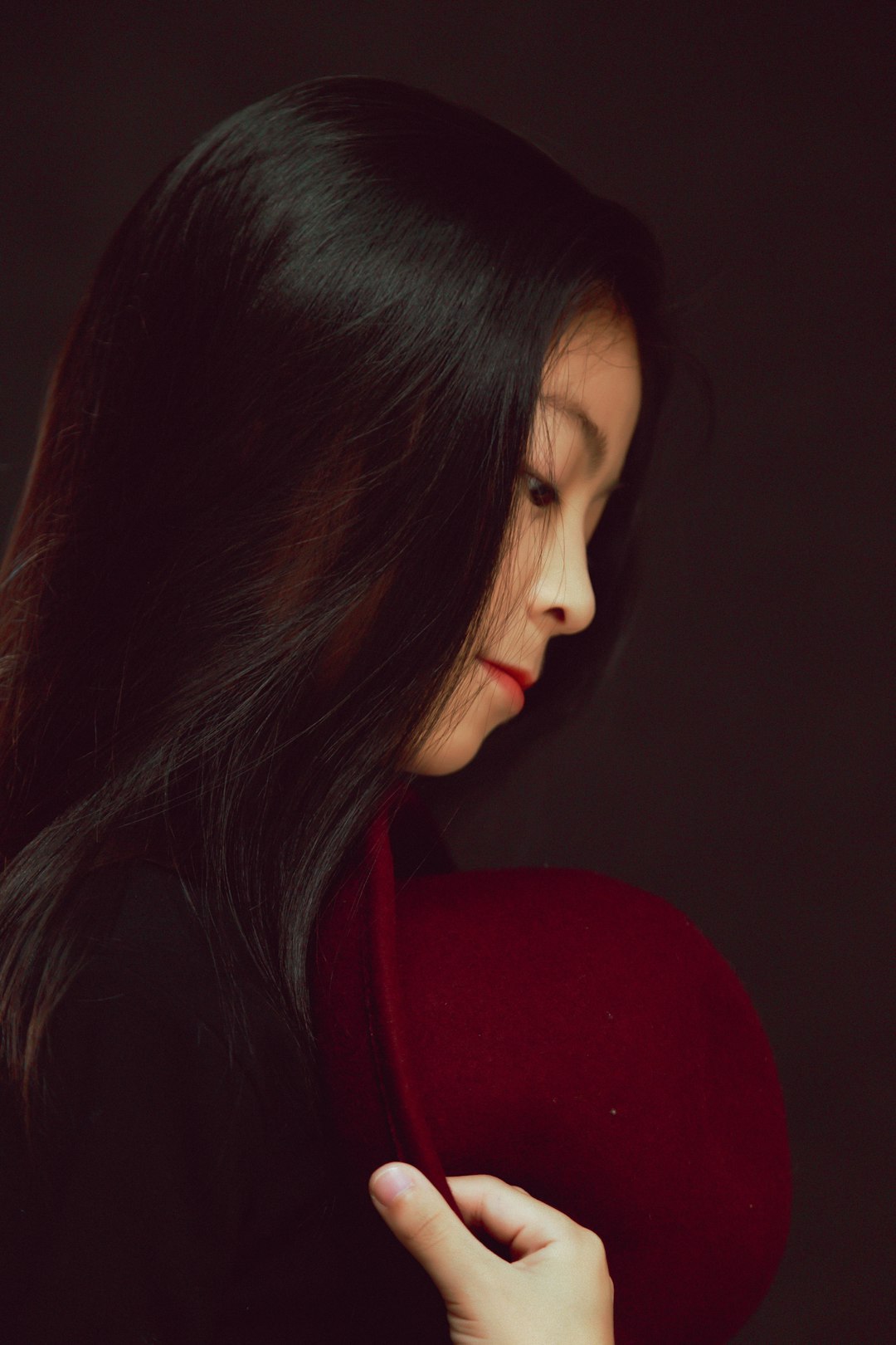 woman in red shirt looking down