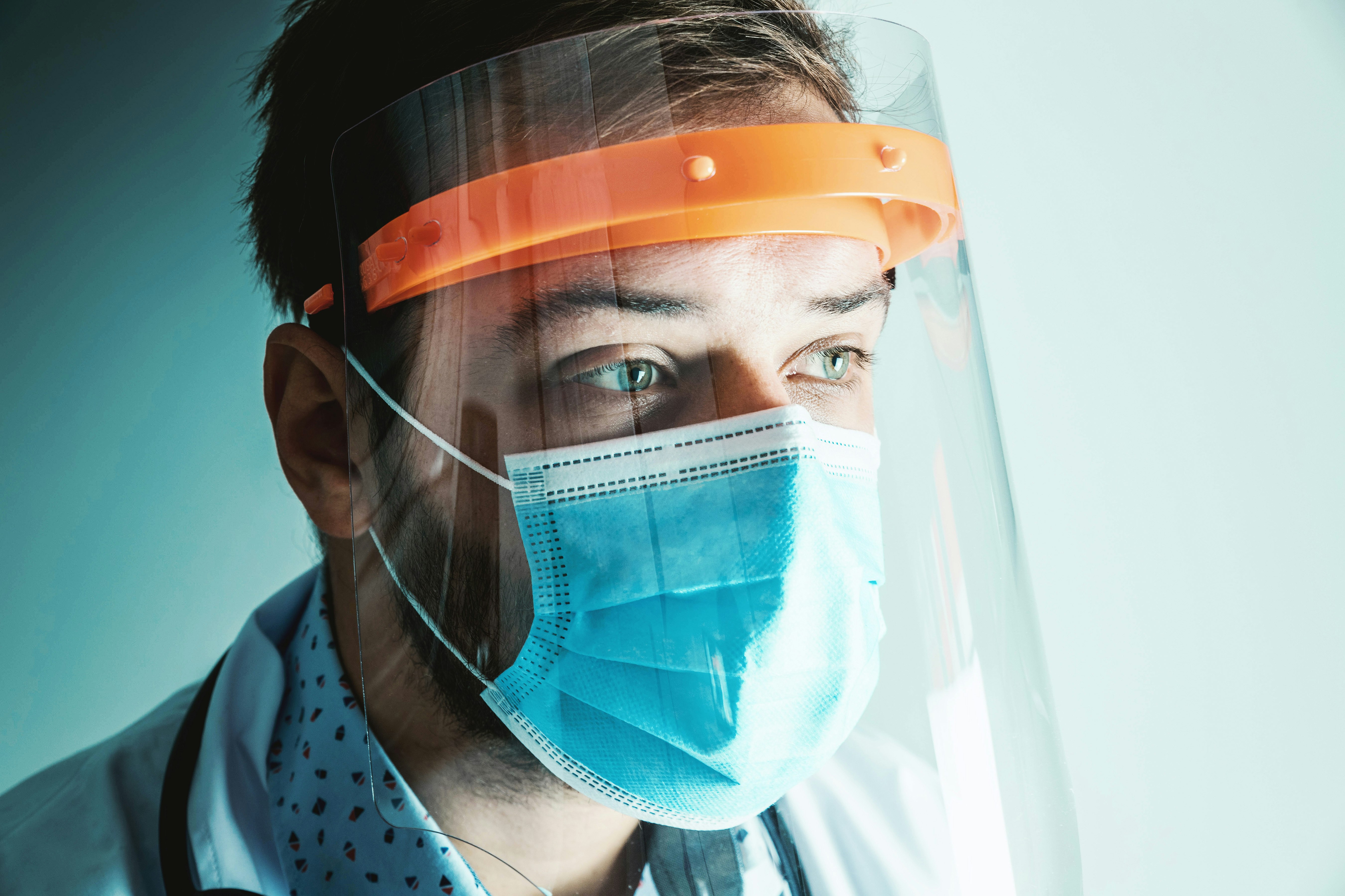 Male Doctor wearing face shield for Coronavirus outbreak or Covid-19. Concept of Covid-19 quarantine.