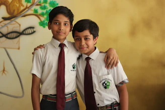 2 boys in school uniform standing