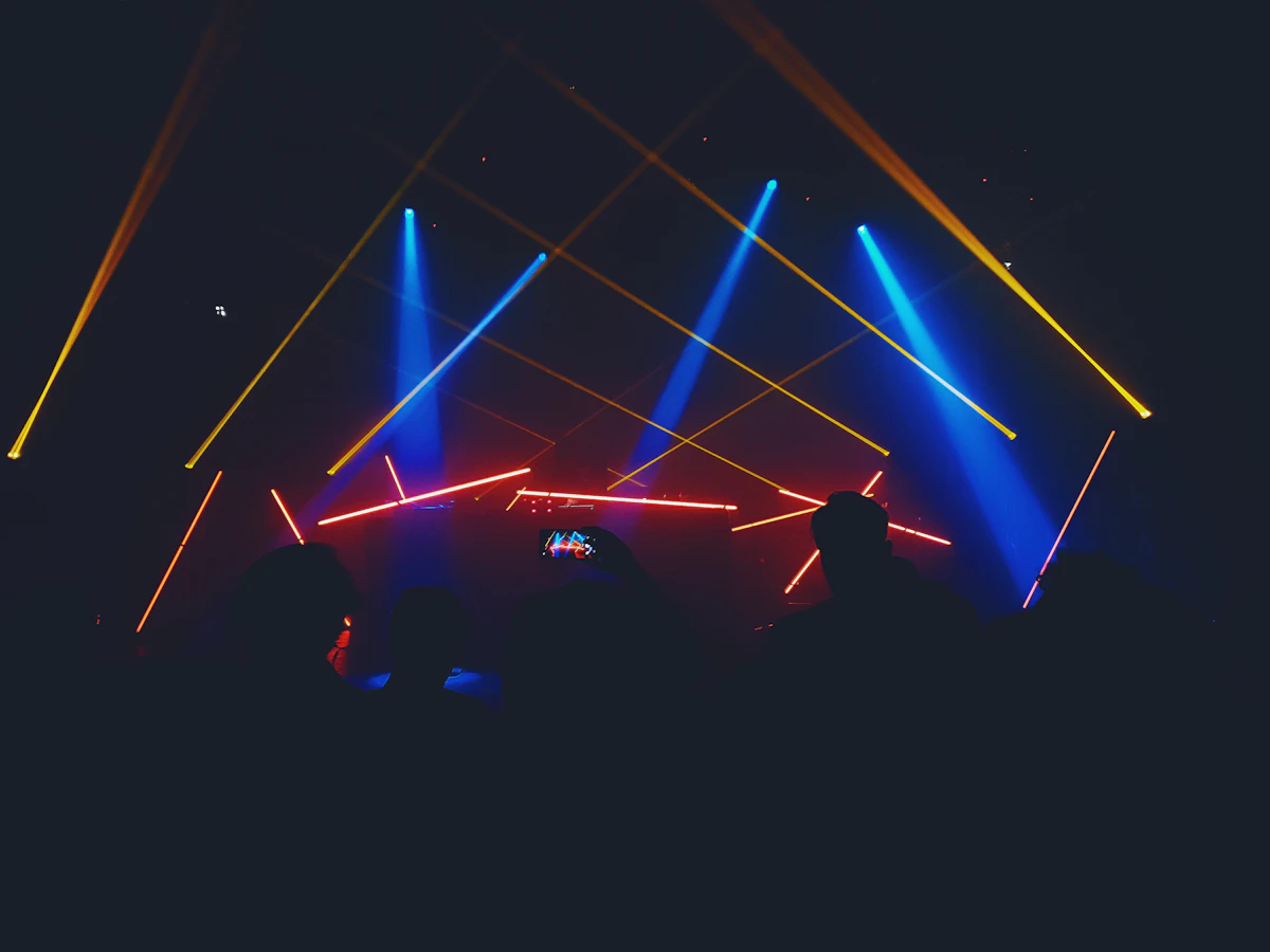 Large live concert production with dramatic laser beams and stage lighting
