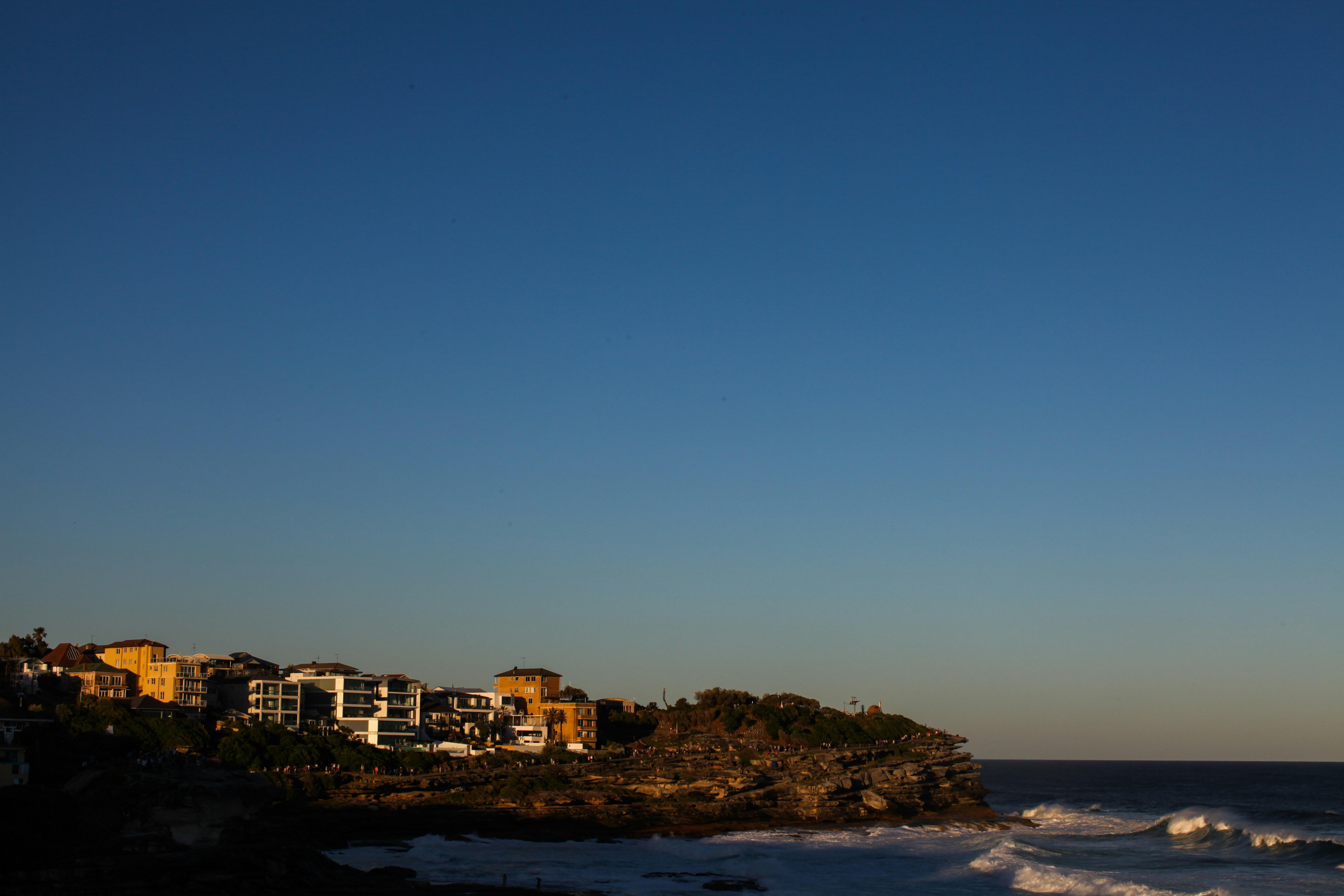 city buildings near body of water during daytime