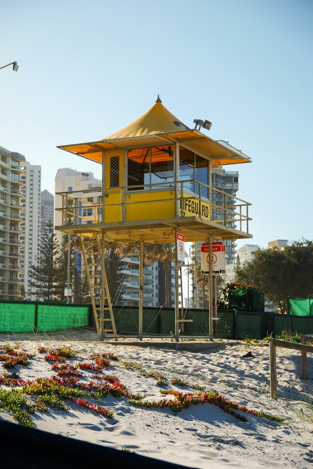 white and brown wooden lifeguard tower