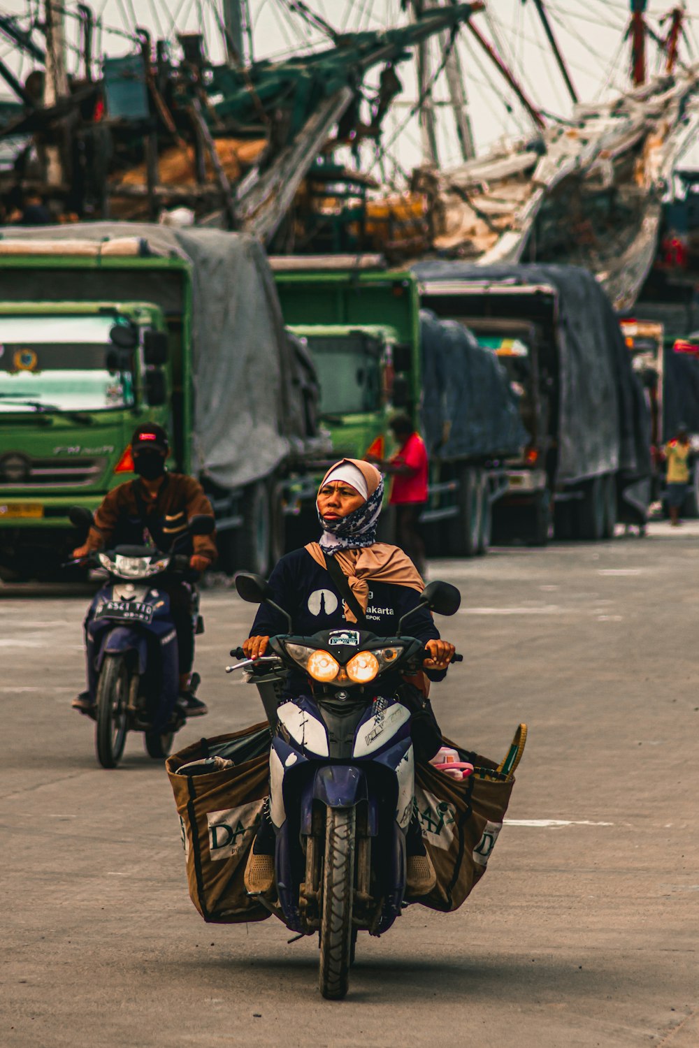 man in black and yellow jacket riding on motorcycle during daytime