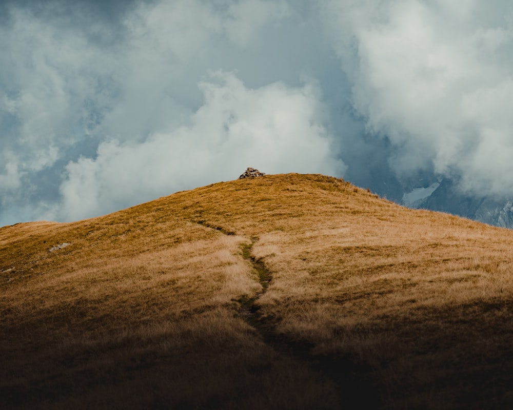 brown and green mountain under white clouds