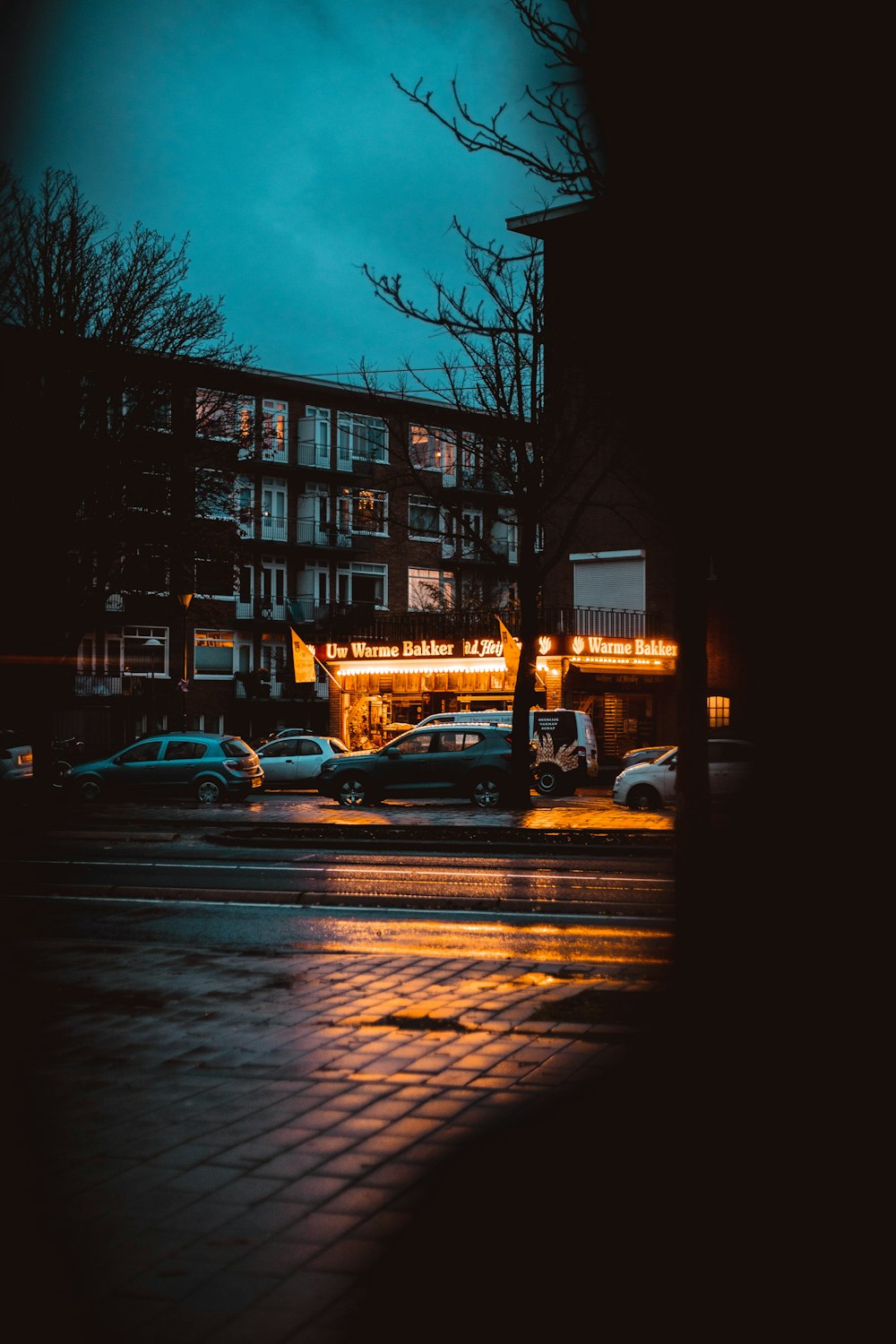 cars parked on side of the road during night time