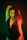 A confident woman posing against a dark backdrop with warm, cinematic lighting highlighting her features.